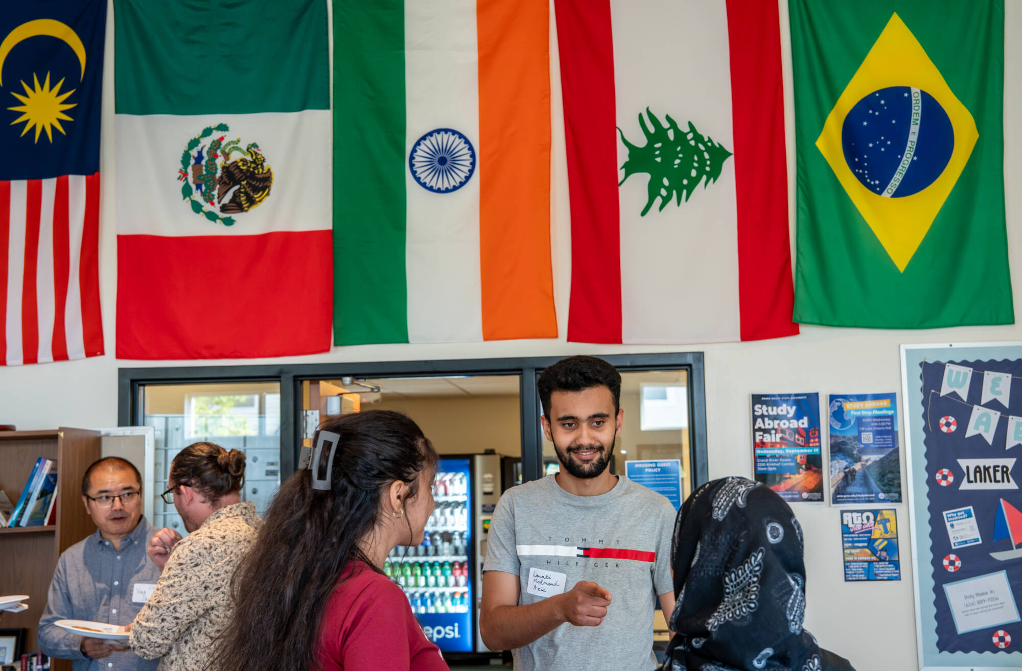 Cybersecurity masters student Mahmoud Aziz Louati talks to other students during a College of Computing and Modern Languages Mixer at the International House on the Valley Campus on September 12.